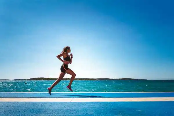 Woman running showing strong leg muscle Stratford